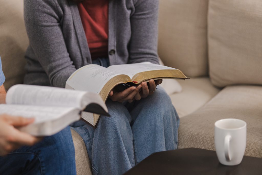 Men and women with Bibles studying together